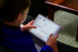 A girl plays on an iPad