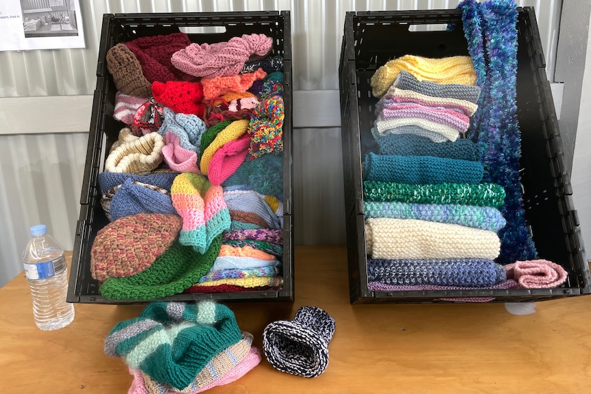two crates of woollen scarves and beanies from Community Support Frankston