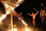 Members of the National Socialist Movement, a neo-Nazi group in the USA, holding a swastika burning in Georgia in April, 2018.