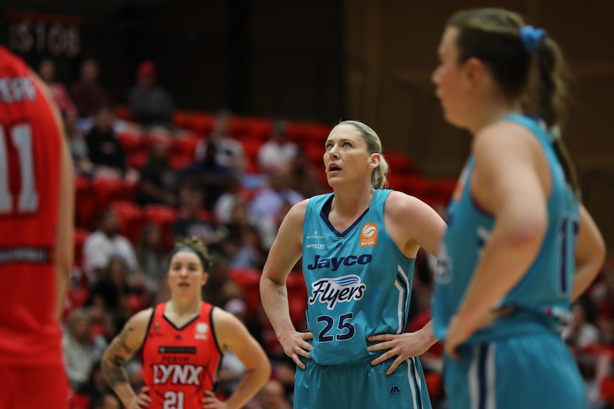 Lauren Jackson puts both hands on her hips and looks up