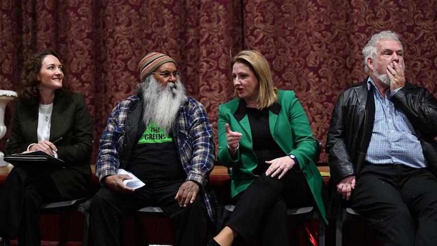 Four candidates chat while waiting for a forum