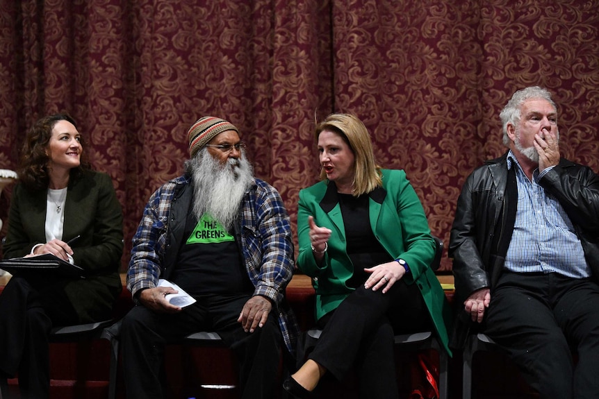 Four candidates chat while waiting for a forum