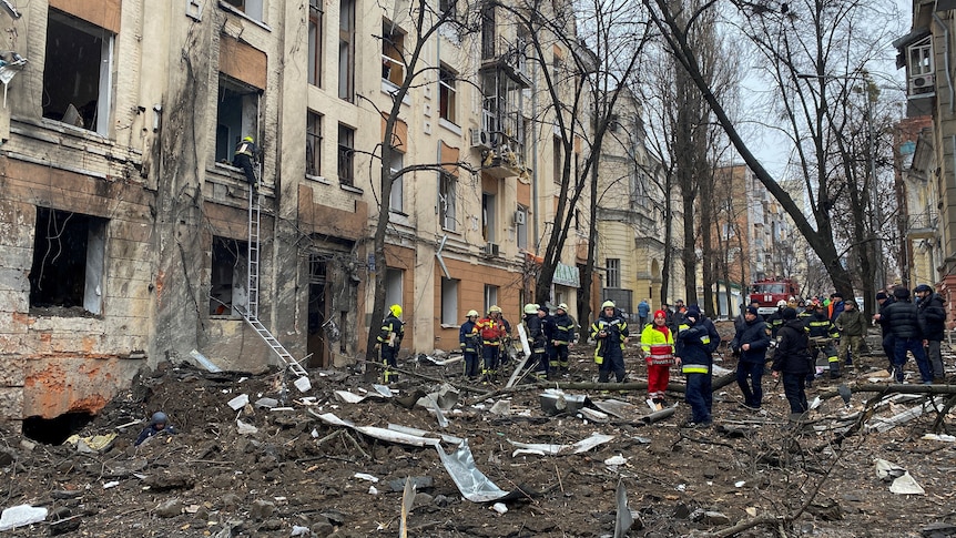 Rescuers work at a site of a residential building damaged by a Russian missile strike