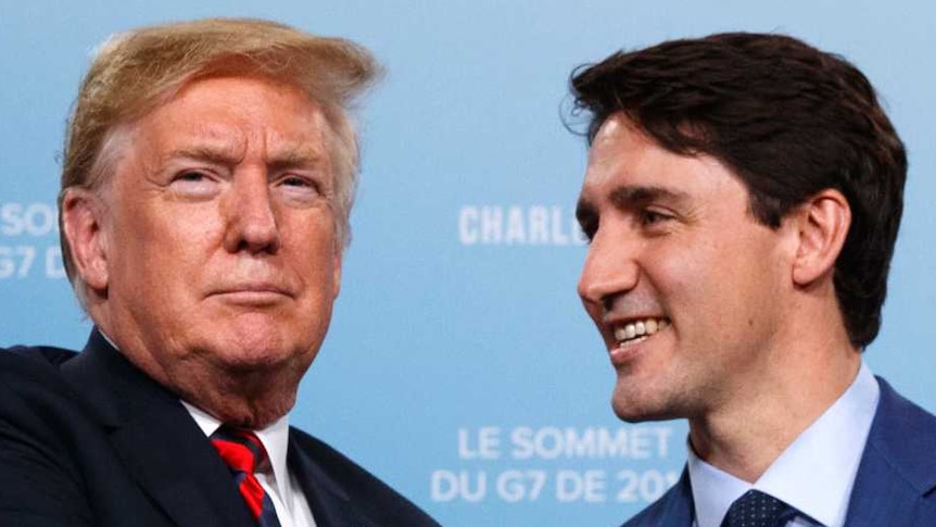 Justin Trudeau smiles and shakes hands with an unsmiling Donald Trump.