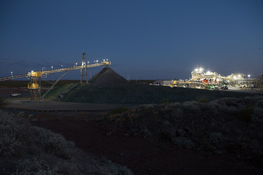 The exterior of a mine at night.