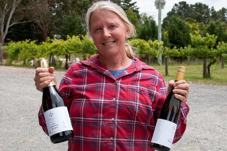 Woman holding two wine bottles