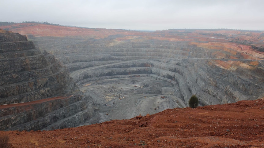 A shot of a tiered open cut gold mine.
