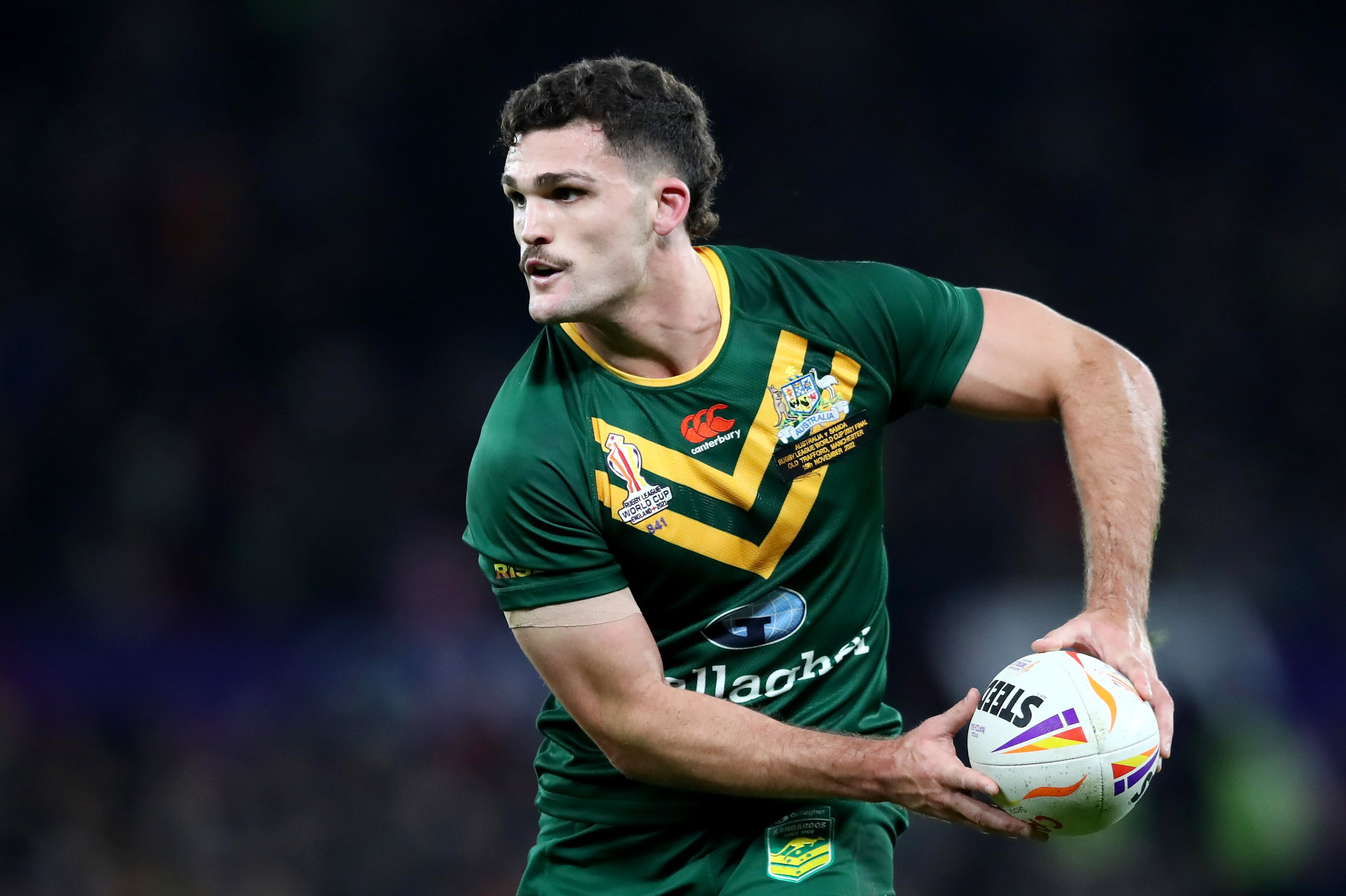 Nathan Cleary holds the ball in both hands as he plays for Australia at the 2022 men's Rugby League World Cup.