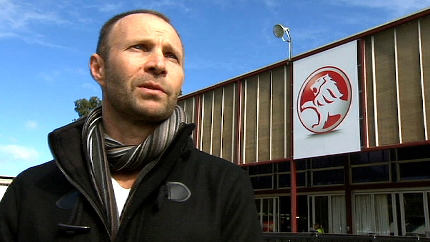 Justin stands outside the Holden factory at Elizabeth.