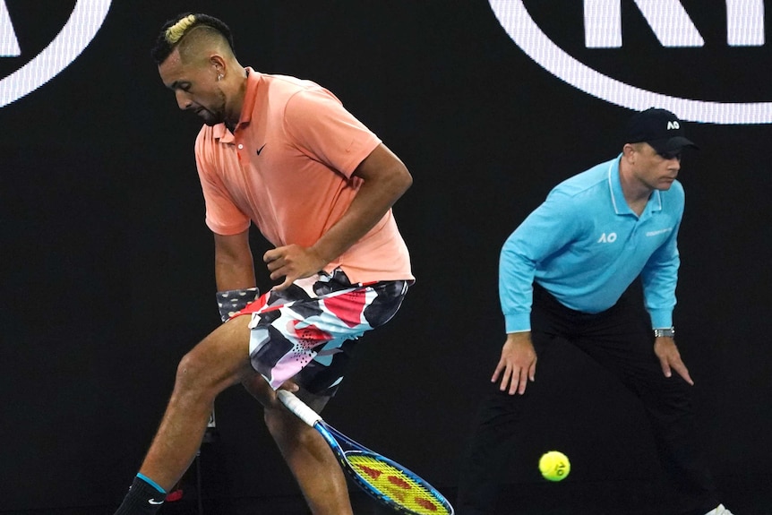 Nick kyrgios plays a shot back between his legs