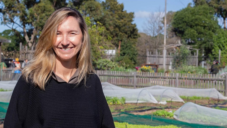 Alana Mann smiling in foreground at the Pocket City Farm, Camperdown Sydney