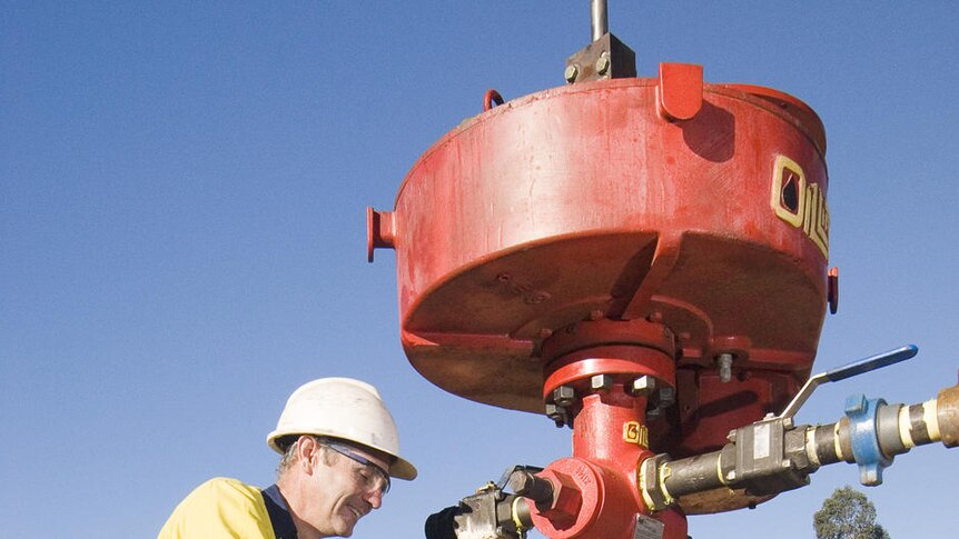 A miner works on a coal seam gas bore