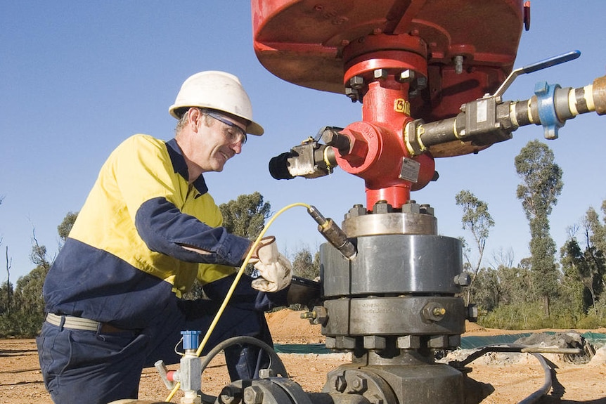 A miner works on a coal seam gas bore hole near Narrabri