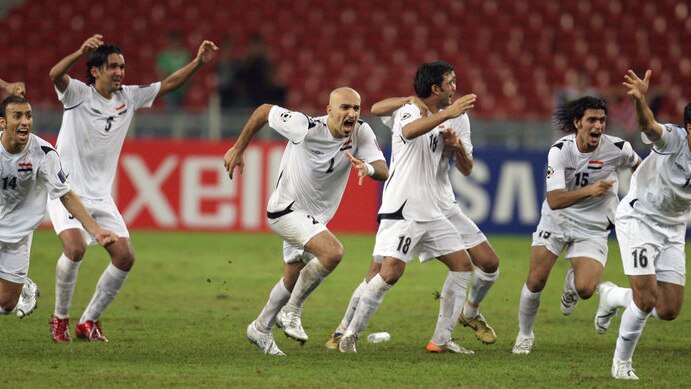 Iraqi players celebrate after defeating South Korea on penalties