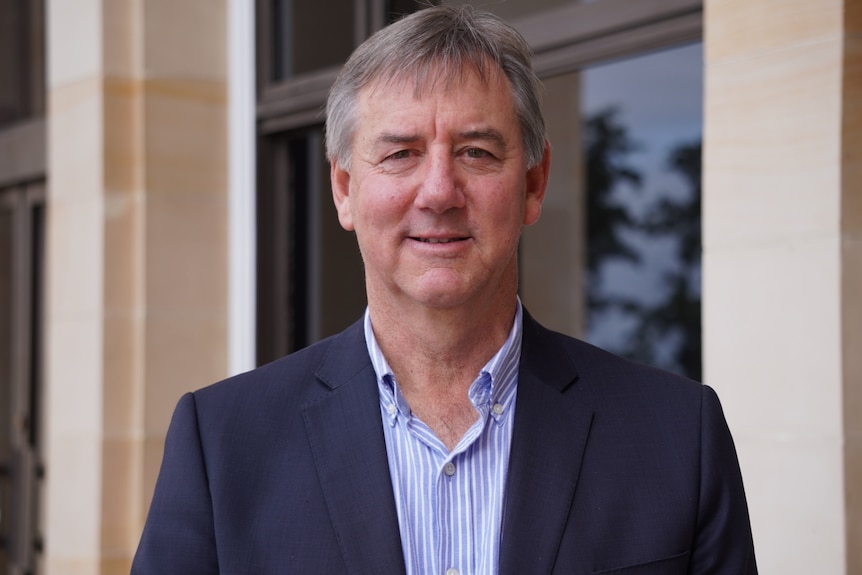 Headshot of Peter Rundle outside of the WA Parliament building.