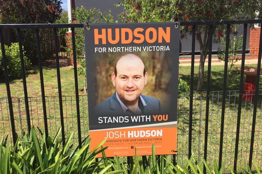 A campaign sign for Josh Hudson is shown hanging on the fence of a house.