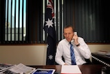 Liberal Party leader Tony Abbott makes phone calls from his office in Sydney