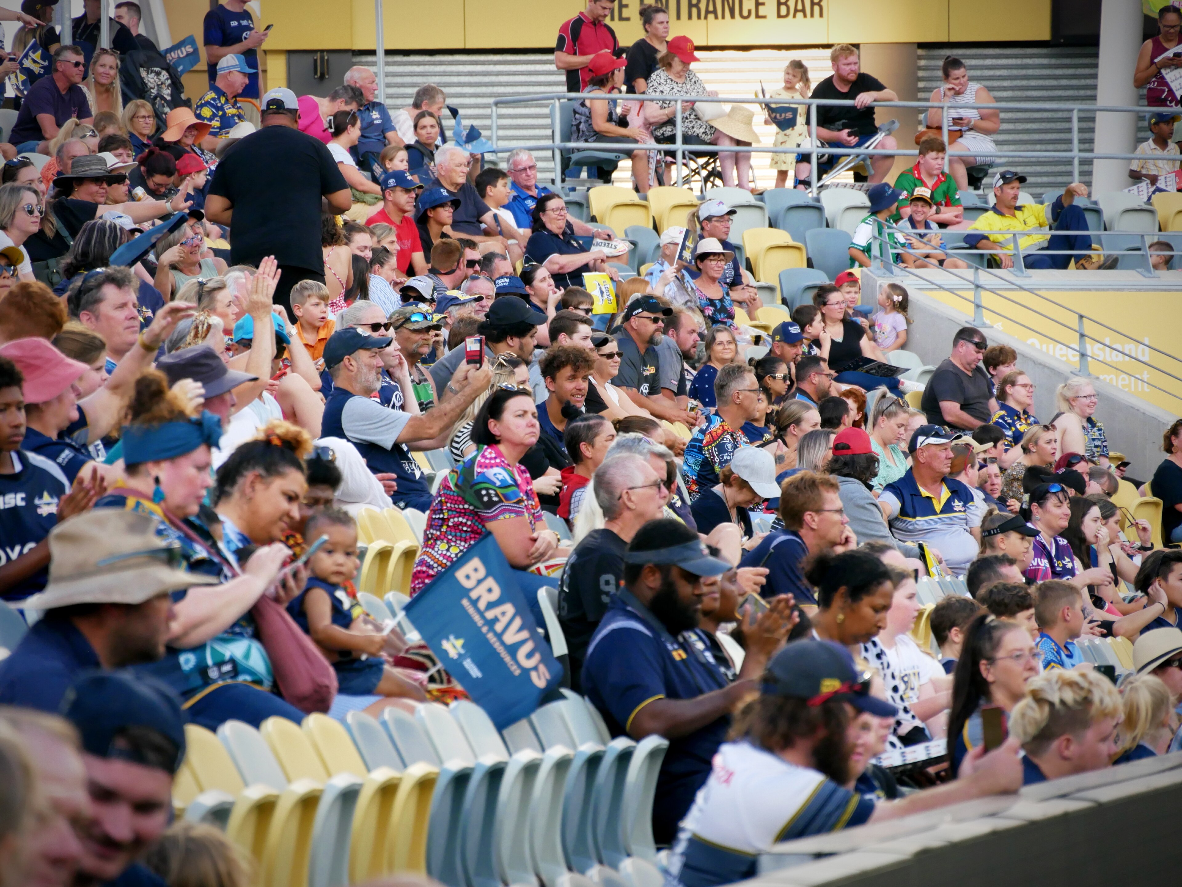 Crowds wearing Cowboys colours seated in a grandstand at the Townsville stadium 