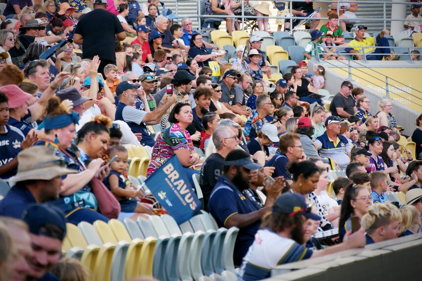 Crowds wearing Cowboys colours seated in a grandstand at the Townsville stadium 