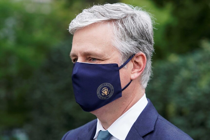 A close up photo of US National Security Advisor Robert O'Brien wearing a facemask with a US logo.