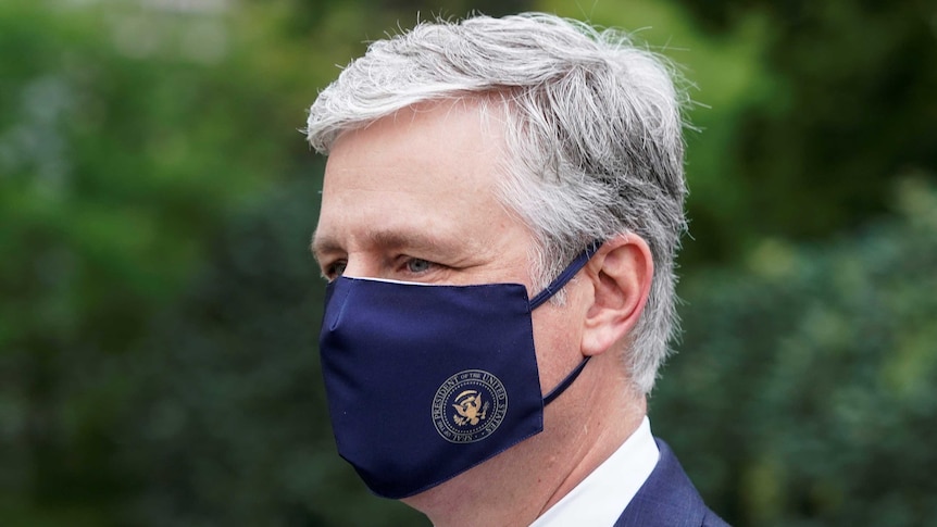 A close up photo of US National Security Advisor Robert O'Brien wearing a facemask with a US logo.