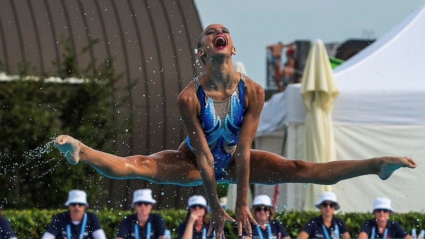 Australian Artistic Swimmer being thrown into air during competition
