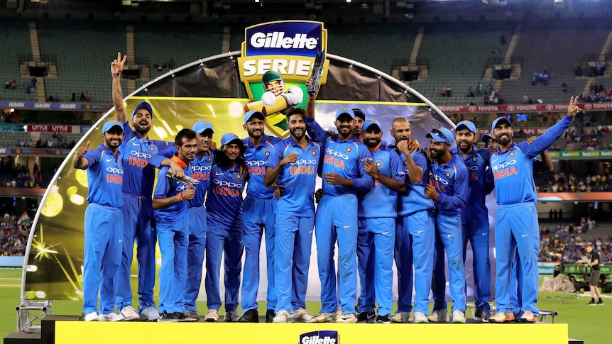 Indian players celebrate on the podium after winning the ODI series against Australia.