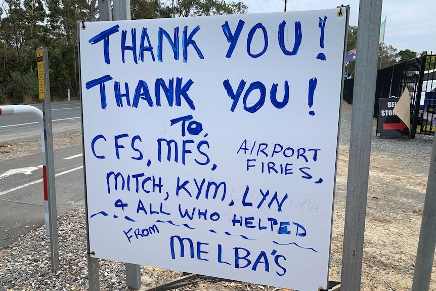 A sign saying "thank you, thank you" to fire fighters.