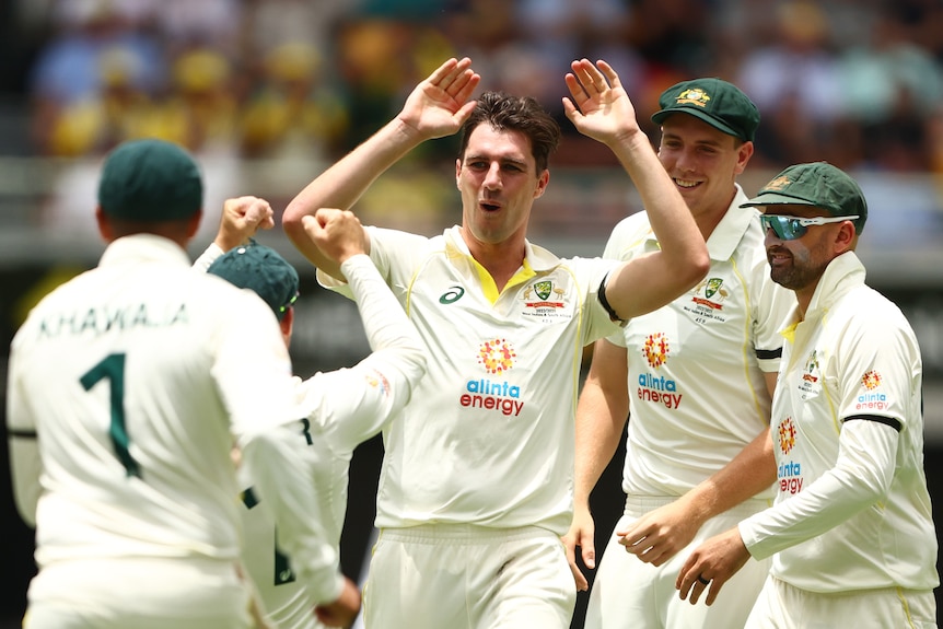 Australia bowler Pat Cummins high-fives his teammates during a Test against South Africa.
