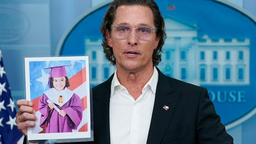 Matthew McConaughey addresses press at White house, holding a picture or Alithia Ramirez who was killed in the school shooting. 