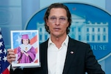 Matthew McConaughey addresses press at White house, holding a picture or Alithia Ramirez who was killed in the school shooting. 