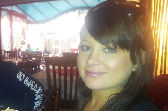 Smiling photo of Shandee Blackburn at a restaurant with a drink.