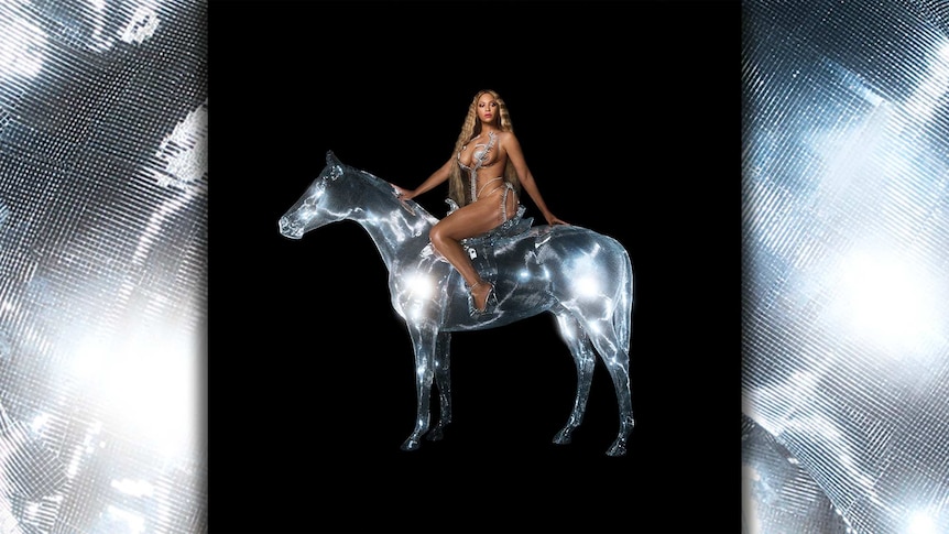 Beyonce sits atop a shiny silver horse wearing very little clothing.