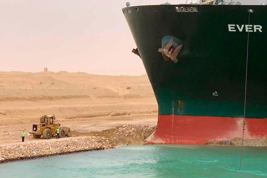 Ever Green, sits with its bow stuck into the wall in the Suez canal.