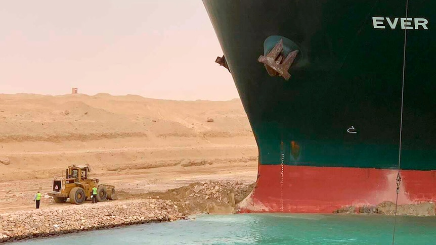 Ever Green, sits with its bow stuck into the wall in the Suez canal.