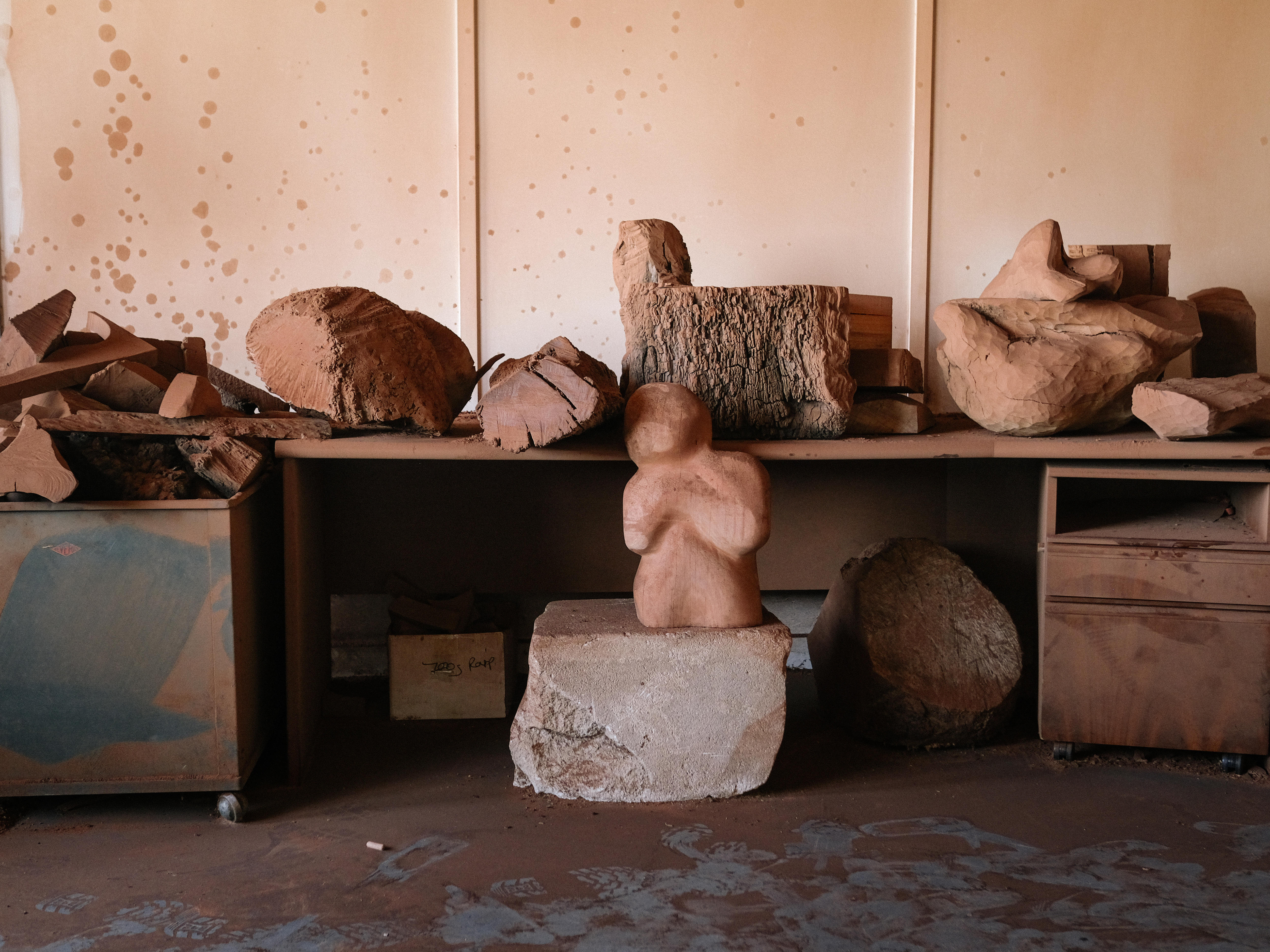 Pieces of wood scraps and half-finished sculptures in the artist's studio