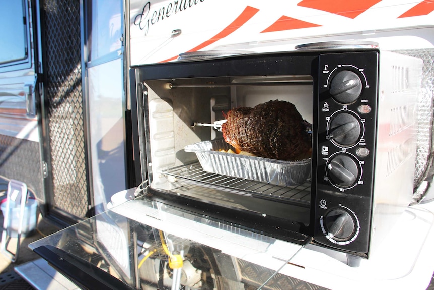 A lamb roast in a rotisserie.