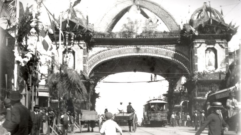 A boy running to the triumphal arch built for the visit to Brisbane by the Duke of York (later George VII) in 1901.