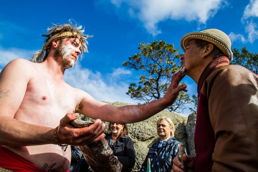 Francis Ling being daubed with white ochre.