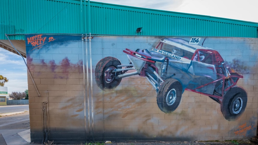 A painting of a dune buggy on a wall