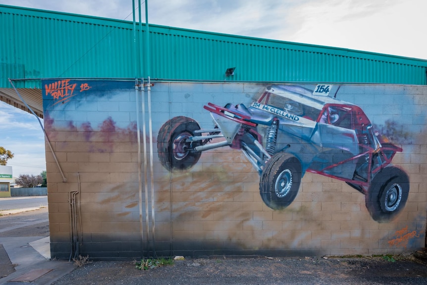 A painting of a dune buggy on a wall