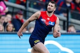 Joel Smith watches a kick during a 2023 AFL match.
