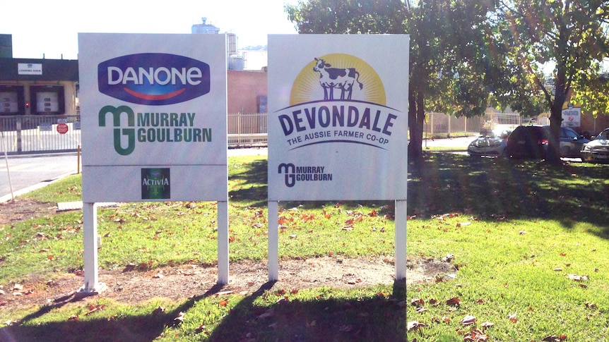 Two signs outside the Murray Goulburn plant read 'Devondale, the Aussie farmer co-op' and 'Danone, Murray Goulburn'.