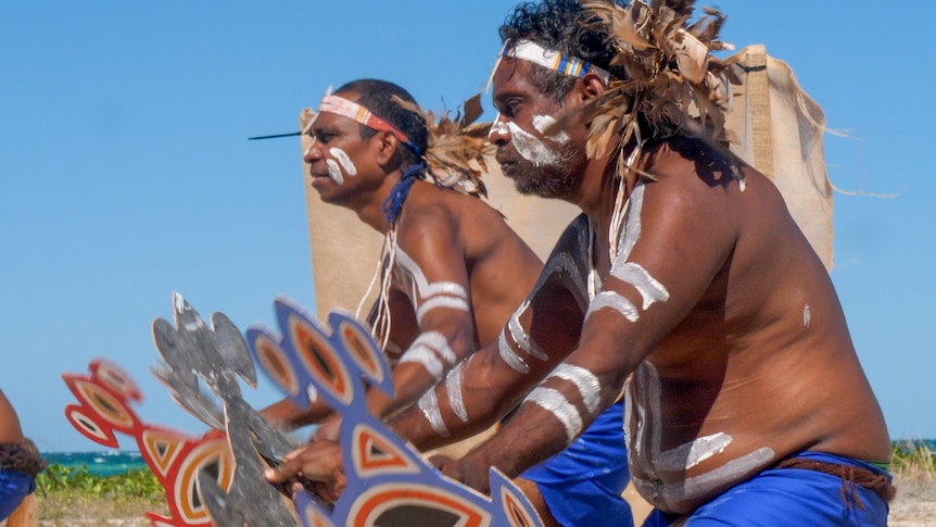 Aboriginal men in ceremonial garb dancing on the Dampier Peninsula