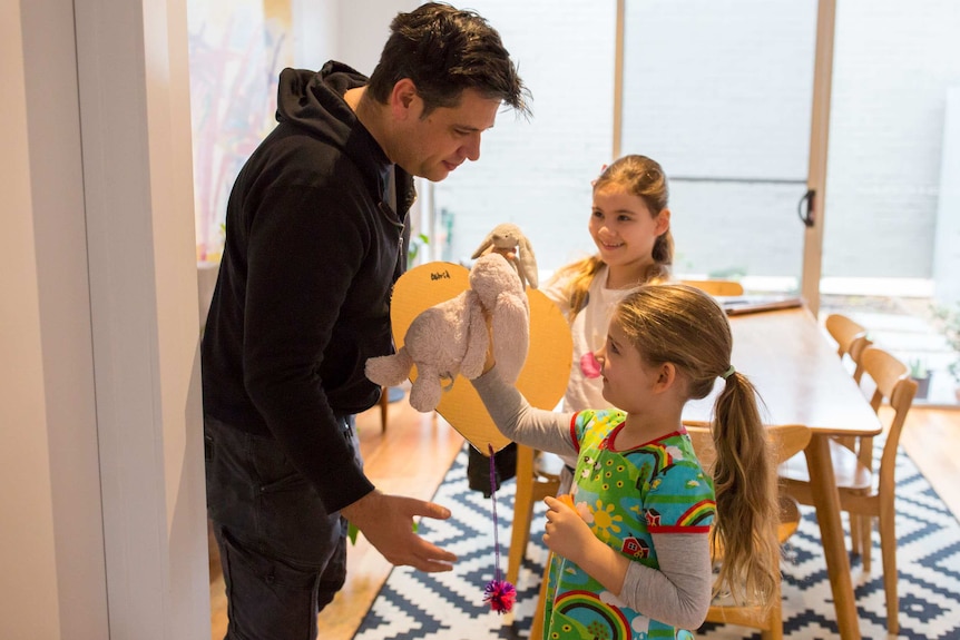 James plays with his daughters before school.