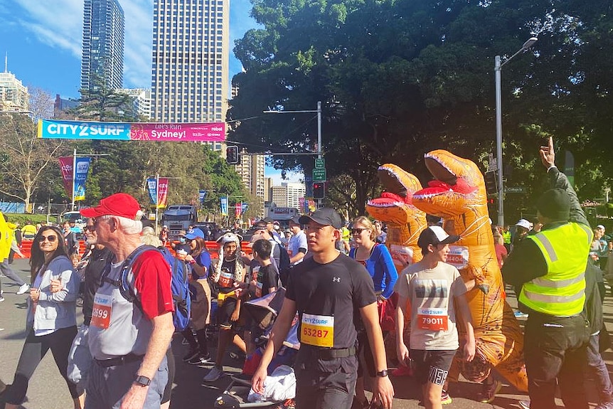 people dressed up in costumes taking part in a run