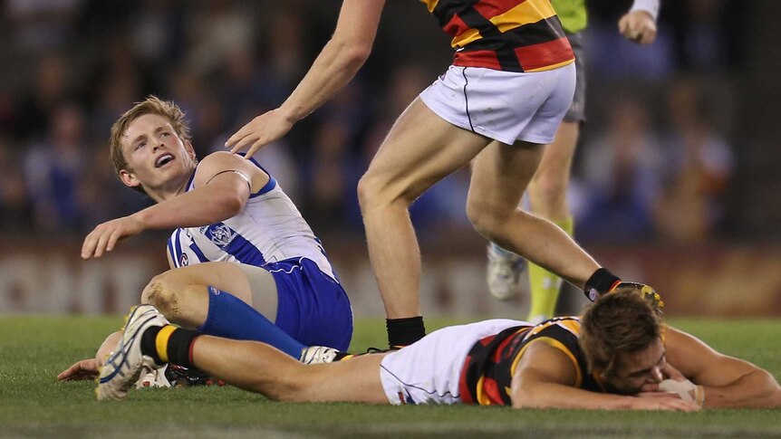 Kangaroos midfielder Jack Ziebell looks on after attempting to spoil Adelaide's Jarryd Lyons.