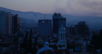 Smoke rises at dawn after US airstrikes hit Damascus.