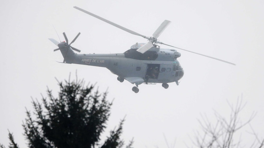 French Air Force helicopter hovers above the scene of a hostage taking where Charlie Hebdo suspects located