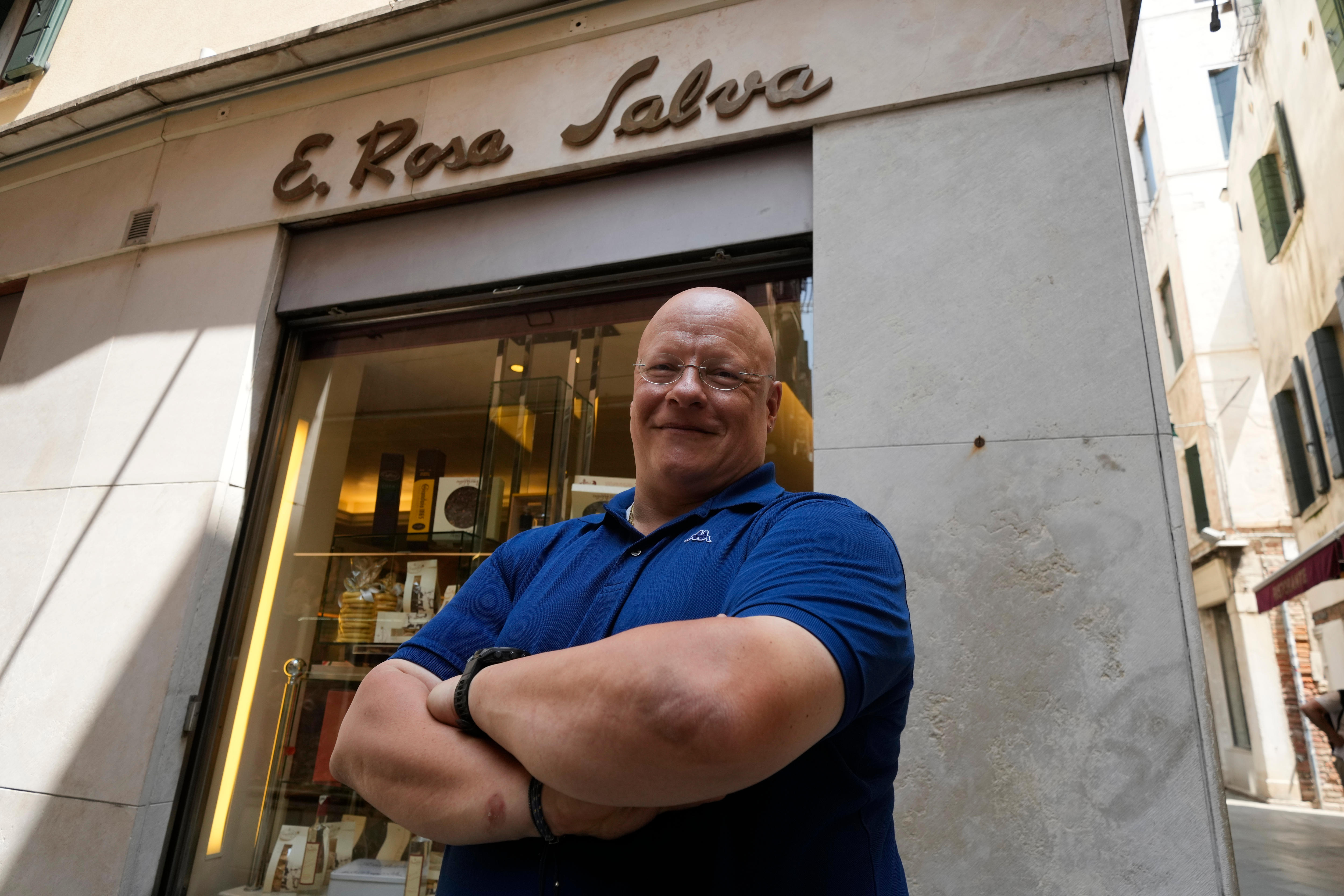 Antonio Rosa Salva smiles while standing outside his pastry shop